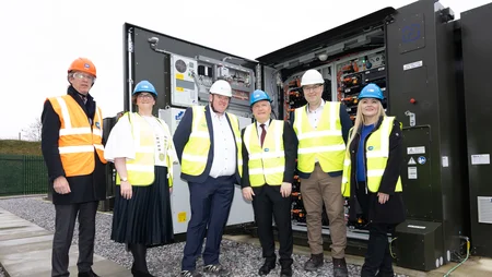 James Cafferty, ESB European Commissioner, and staff members standing in front of battery solution unit on BESS 2 launch day.