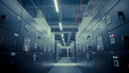 A corridor inside a data centre, lined with rows of server racks. 